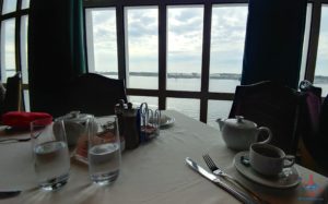 a table with a white tablecloth and a teapot and glasses