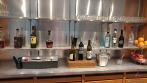 bottles on a counter with shelves