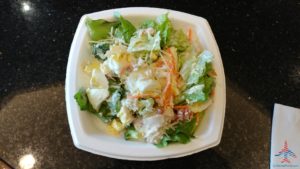 a bowl of salad on a black surface