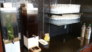 a black counter with a black tile wall and a black tile floor