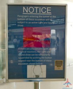 a notice board with a man in the background