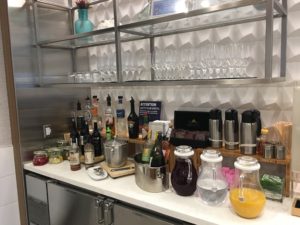 a counter with bottles and glasses on it