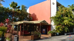 a building with a red wall and trees