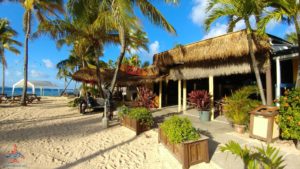 a building with palm trees and a beach