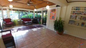 a room with a tile floor and a couch and a plant