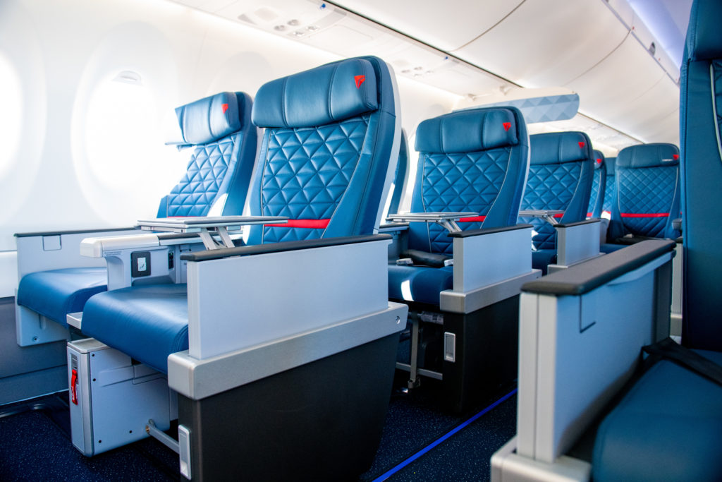 a row of blue seats on an airplane