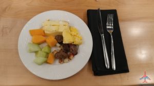 a plate of food on a napkin and fork