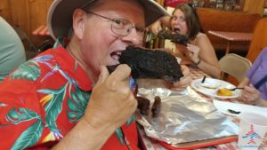 a man eating a piece of meat