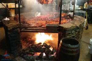 a fire pit with meat over it