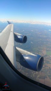 an airplane wing with blue engines