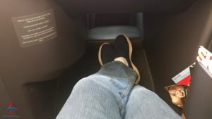 a person's legs and feet in a seat