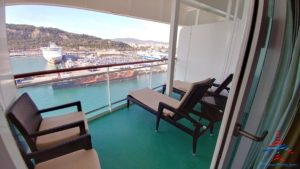 a deck with chairs and a view of the water