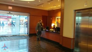 a man standing at a counter in a hotel