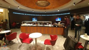 a man standing behind a counter in a restaurant