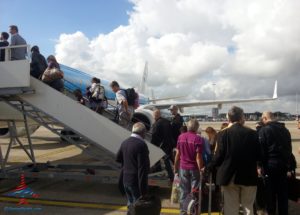 a group of people boarding an airplane