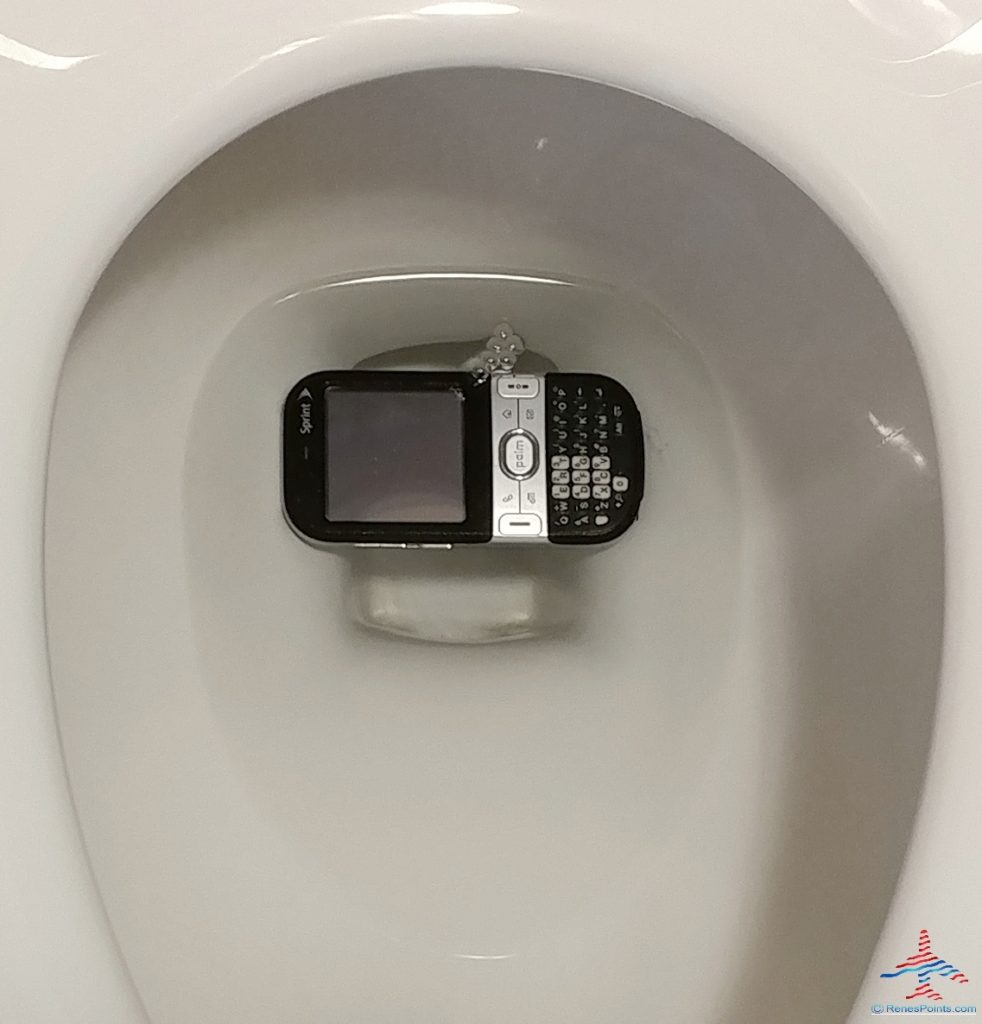 photo of a cell phone dropped into a toilet with bubbles renespoints travel blog Eye of the Flyer