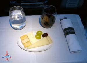 a plate of cheese grapes and grapes on a table