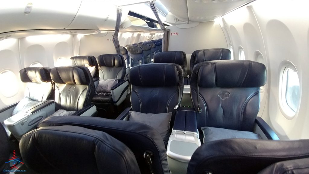 the inside of an airplane with black seats