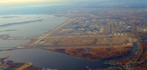 an aerial view of a runway and water