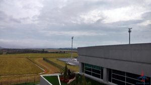 a building with grass and a field