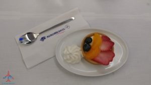 a plate with fruit and whipped cream on it