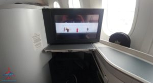 a tv on a shelf in an airplane