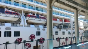 a large white ship with boats on the deck