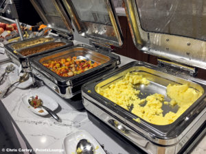 Ground beef, the Austin Scramble, and scrambled eggs are seen at the breakfast buffet inside the Delta Sky Club Austin airport lounge at Austin-Bergstrom International Airport (AUS) in Austin, Texas. Photo © Chris Carley / PointsLounge