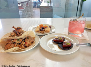 Lunch items such as chicken soft tacos, tuna tartare, dried apricots, and cheeses are seen at he Delta Sky Club Austin airport lounge in Austin, Texas. Photo © Chris Carley / PointsLounge