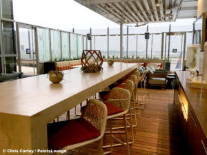 Chairs line a long table on the Sky Deck patio of the Delta Sky Club Austin airport lounge in Austin, Texas. Photo © Chris Carley / PointsLounge