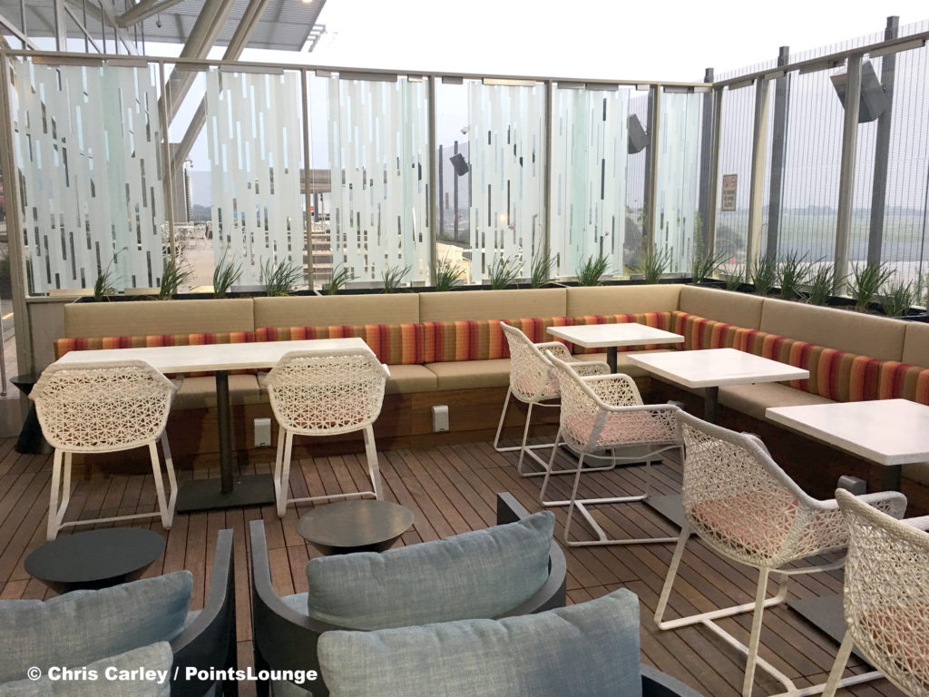 Tables and chairs are seen on the Sky Deck patio of the Delta Sky Club Austin airport lounge in Austin, Texas. Photo © Chris Carley / PointsLounge