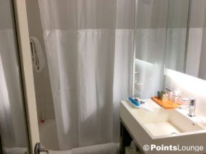 A view of the bathroom and shower area in a room at the Stewart Hotel New York City in midtown Manhattan, NY.