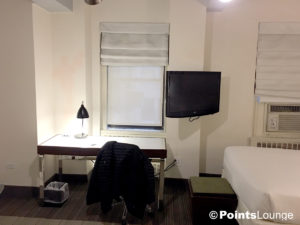 Desk and adjacent area in a room at at the Stewart Hotel New York City in Manhattan, NY.