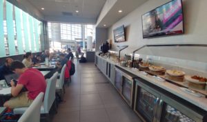 a food court with people sitting at tables