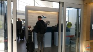 a man standing in front of a glass door