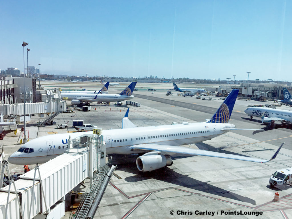 United Airlines Boeing 757 tail number N17133 at gate 71B and other aircraft are seen from the United Club LAX airport lounge in Los Angeles, California. © Chris Carley / PointsLounge