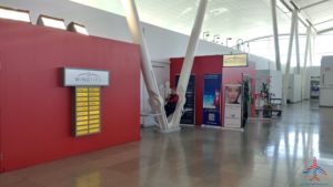 a red wall with white pillars