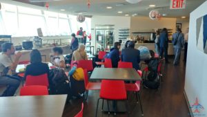 a group of people sitting at tables in a cafeteria