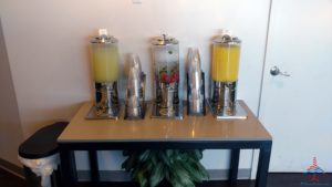 a group of juice dispensers on a table