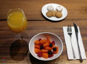 a plate of fruit and a glass of juice