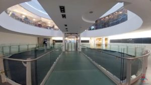 a walkway with a glass ceiling