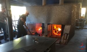 a man standing in front of a fireplace