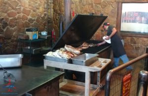 a man cooking meat on a grill