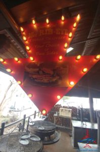 a red arrow shaped sign with lights