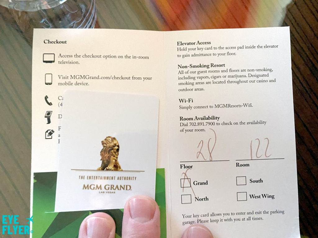 An MGM Grand hotel key card packet with the room number written inside.