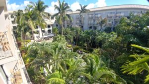 a building with palm trees and a building