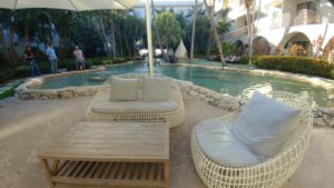 a pool with a lounge chair and a table