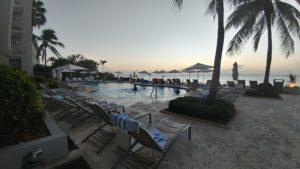 a pool with lounge chairs and umbrellas