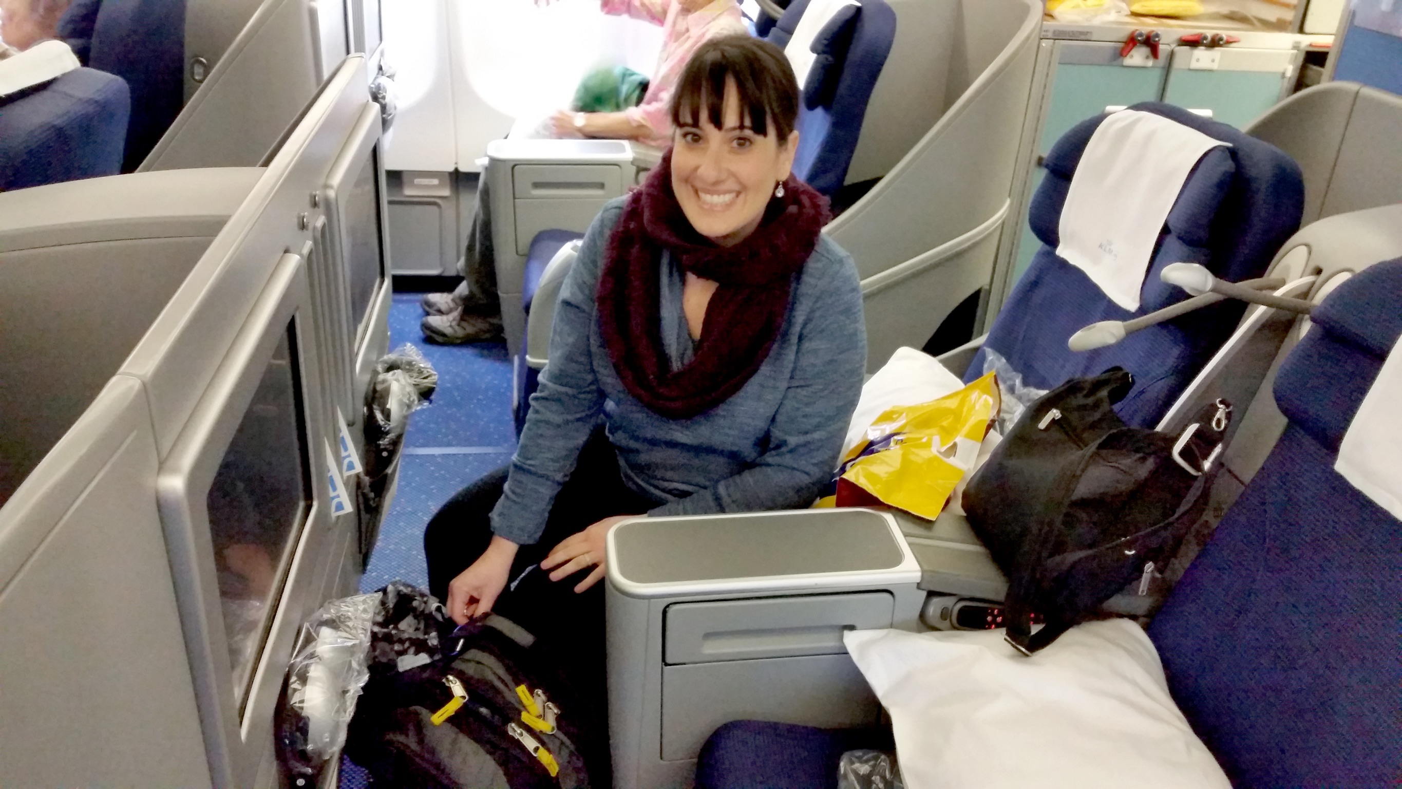 My wife enjoying KLM business class -- paid for entirely with points and miles earned from travel credit cards.