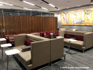 A seating area with tables and booths are seen inside the Delta Sky Club Austin airport lounge at Austin-Bergstrom International Airport (AUS) in Austin, Texas. Photo © Chris Carley / PointsLounge